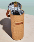 Brown insulated wine bag with a bottle of wine on a light marble surface.