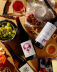 Las Jaras Chenin Blanc and Sweet Berry natural wines from California with fresh fruit flavors served with cheese, grapes, and nuts on wooden table for Mysa Natural Wine