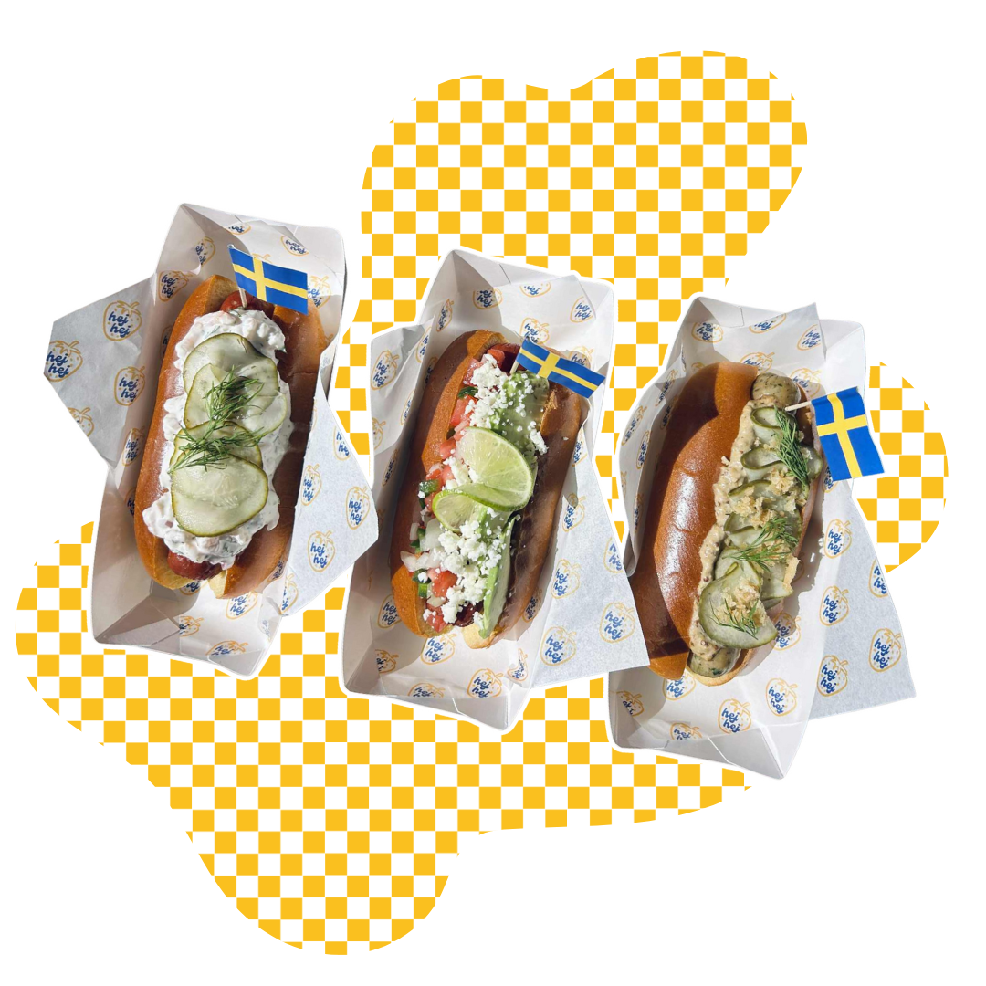 Three hot dogs with various toppings on a yellow and white checkered background