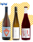 Three wine bottles with labels on a yellow and white checkered background, featuring the brand 'hej hej'.
