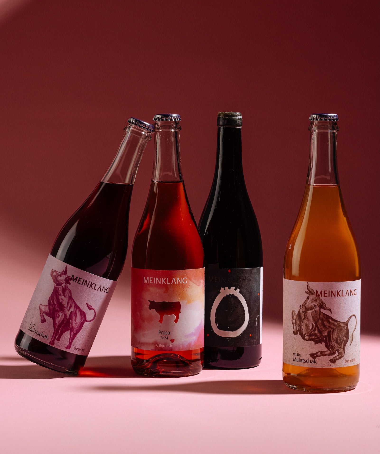 Meinklang natural wine collection including Mulatschak red, Prosa rosé, and white wines from Austria on pink background for Mysa Natural Wine